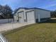 Large detached garage with three bays and a white gravel drive at 3289 Pellam Blvd, Port Charlotte, FL 33948