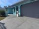 Well-maintained home with a grey two-car garage and decorative statues at 3289 Pellam Blvd, Port Charlotte, FL 33948