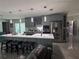 Modern kitchen with sleek gray cabinetry, stainless steel appliances and a large island with seating at 3289 Pellam Blvd, Port Charlotte, FL 33948