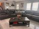 Spacious living room with a large sectional sofa, coffee table and modern decor at 3289 Pellam Blvd, Port Charlotte, FL 33948