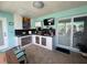 Outdoor kitchen with custom counters, gas grill, and outdoor seating at 3289 Pellam Blvd, Port Charlotte, FL 33948