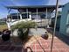 Brick patio featuring RV parking spot, plants, and greenery at 3289 Pellam Blvd, Port Charlotte, FL 33948