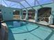 Relaxing enclosed pool area with blue turquoise paint and classical statue accents at 3289 Pellam Blvd, Port Charlotte, FL 33948