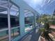 Exterior of an enclosed pool area featuring a crystal-clear pool and sun-drenched deck at 3289 Pellam Blvd, Port Charlotte, FL 33948