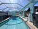 Sparkling pool with an enclosed patio and manicured landscaping at 3289 Pellam Blvd, Port Charlotte, FL 33948