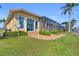Lush backyard with well-maintained landscaping leading to a screened-in patio at 3321 Tripoli Blvd, Punta Gorda, FL 33950