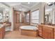 Bright bathroom featuring a corner soaking tub, glass shower, and dual vanities at 3321 Tripoli Blvd, Punta Gorda, FL 33950