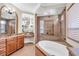 Bright bathroom featuring a corner soaking tub, glass shower, and dual vanities at 3321 Tripoli Blvd, Punta Gorda, FL 33950
