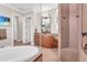Corner soaking tub, glass shower, dual vanities and a beach scene on the TV at 3321 Tripoli Blvd, Punta Gorda, FL 33950