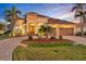 Stunning home exterior with tropical landscaping, barrel tile roof, and brick paved driveway at 3321 Tripoli Blvd, Punta Gorda, FL 33950