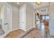 Hallway leading to a bright living area with tiled floors and neutral walls at 3321 Tripoli Blvd, Punta Gorda, FL 33950