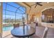 Outdoor patio with screened-in pool and waterfront view at 3321 Tripoli Blvd, Punta Gorda, FL 33950