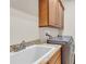 Laundry room with granite counters, undermount utility sink, and stainless washer dryer at 3321 Tripoli Blvd, Punta Gorda, FL 33950