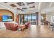 Spacious living room featuring coffered ceiling, tile flooring, and access to the outdoor patio at 3321 Tripoli Blvd, Punta Gorda, FL 33950