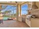 Outdoor kitchen with built-in grill overlooking screened in pool and waterfront at 3321 Tripoli Blvd, Punta Gorda, FL 33950