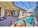 Inviting screened-in pool and spa area with brick pavers and seamless access to indoor living space at 3321 Tripoli Blvd, Punta Gorda, FL 33950