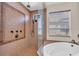 Close-up of shower with beige tile surround and a separate soaking tub with jets at 3321 Tripoli Blvd, Punta Gorda, FL 33950