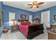 Elegant bedroom featuring a wooden sleigh bed, white tile floors, and Tiffany-style lamps at 4504 Vaquero St, North Port, FL 34286