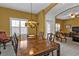 Open dining room area featuring a wooden dining set with views of living area and front entrance at 4504 Vaquero St, North Port, FL 34286