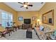 Cozy living room with natural light, comfortable seating, and a TV entertainment center at 4504 Vaquero St, North Port, FL 34286