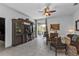 Open living room area with a TV, sliding door access to the outside patio, and comfortable seating at 4504 Vaquero St, North Port, FL 34286