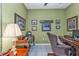 Office with green walls featuring tile flooring, a ceiling fan, and a leather executive chair at 4504 Vaquero St, North Port, FL 34286