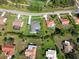 Aerial view showing the property's lush yard, screened pool, well-maintained landscaping, and neighborhood setting at 5131 Appomattox Dr, North Port, FL 34287