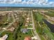 Expansive aerial view showing the home's location within a neighborhood near a golf course and major roadway at 5131 Appomattox Dr, North Port, FL 34287