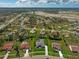 Wide aerial view of a home in a large community and nearby commercial and green spaces at 5131 Appomattox Dr, North Port, FL 34287