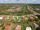 Aerial view of property showcasing landscaping, golf course proximity and neighborhood layout in a serene setting at 5131 Appomattox Dr, North Port, FL 34287
