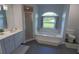 Bathroom featuring a soaking tub, a vanity with dual sinks, and a walk-in shower at 5131 Appomattox Dr, North Port, FL 34287