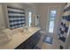 Bright bathroom with a blue and white striped shower curtain and a door to the pool area at 5131 Appomattox Dr, North Port, FL 34287