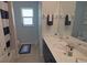 Bathroom featuring a vanity with a marble countertop, stylish decor, and a window letting in natural light at 5131 Appomattox Dr, North Port, FL 34287