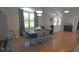 Open dining room with large window, stylish chandelier, and tile flooring at 5131 Appomattox Dr, North Port, FL 34287
