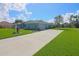 Single-story home featuring a long concrete driveway and a well-kept lawn at 5131 Appomattox Dr, North Port, FL 34287