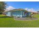 Charming blue one-story home featuring a well-manicured lawn and beautifully landscaped garden at 5131 Appomattox Dr, North Port, FL 34287