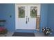 Charming front entrance featuring double doors, seasonal decor, and welcoming floral arrangements at 5131 Appomattox Dr, North Port, FL 34287