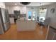 Open kitchen area with white cabinets, a stainless steel fridge, and adjacent dining area at 5131 Appomattox Dr, North Port, FL 34287