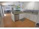 Bright kitchen featuring white cabinets, granite countertops, stainless steel appliances and decorative backsplash at 5131 Appomattox Dr, North Port, FL 34287