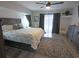 Bright main bedroom features a ceiling fan, wood flooring, and a sliding glass door at 5131 Appomattox Dr, North Port, FL 34287