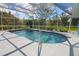Sparkling pool enclosed by a screen, accented with mature landscaping and a patio at 5131 Appomattox Dr, North Port, FL 34287