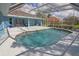 Backyard pool surrounded by a screened enclosure, lush landscaping, and inviting scenery at 5131 Appomattox Dr, North Port, FL 34287