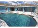 Sparkling in-ground pool surrounded by a screened enclosure, offering a private and relaxing outdoor space at 5131 Appomattox Dr, North Port, FL 34287