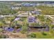 Aerial view of waterfront home with pool, dock, solar panels, and lush landscaping at 8230 Agate St, Port Charlotte, FL 33981