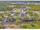 Aerial view of waterfront home with pool, dock, solar panels, and lush landscaping at 8230 Agate St, Port Charlotte, FL 33981