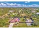 Aerial view of a home on a large, landscaped lot that includes a boat parking area and a red metal roof at 8230 Agate St, Port Charlotte, FL 33981
