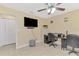 Bright bedroom with large television, ceiling fan, tile floors and desk area at 8230 Agate St, Port Charlotte, FL 33981