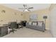 Bright bedroom with ceiling fan, tile floors, desk area and a comfortable sofa at 8230 Agate St, Port Charlotte, FL 33981