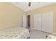 Comfortable bedroom featuring twin beds, tile floors, closet and open doorway at 8230 Agate St, Port Charlotte, FL 33981