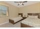 Comfortable bedroom with twin beds, a window with a view, and neutral decor at 8230 Agate St, Port Charlotte, FL 33981